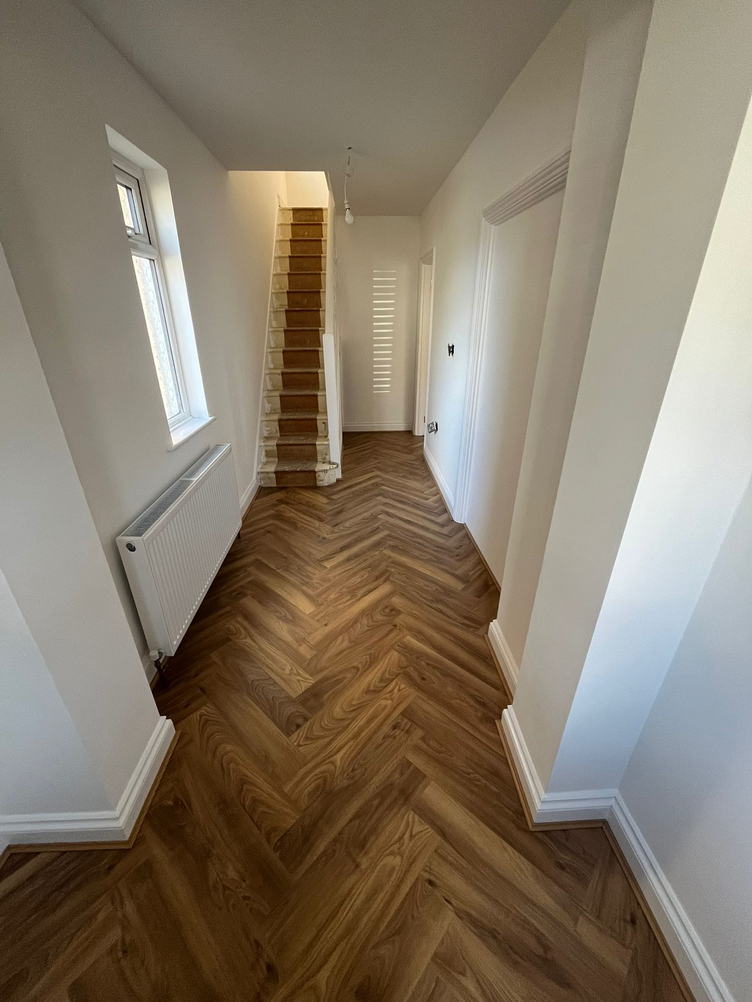 Completed flooring running through a hallway